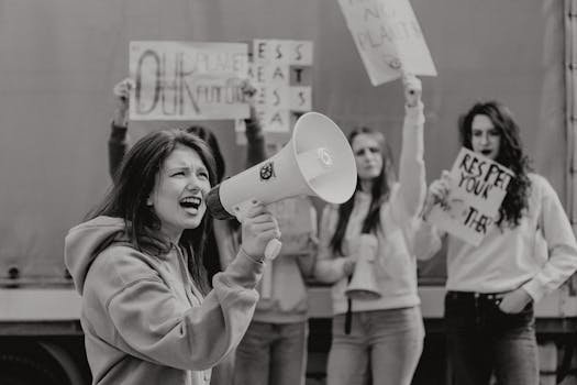 Group of activists protesting with signs and a megaphone for environmental causes.